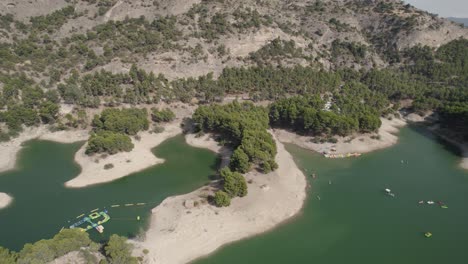 Landing-drone-shot-of-La-isla-"el-chorro,-a-famous-vacation,-travel-spot-of-Ardales-natural-park-in-Malaga-Lake-District-atraction-of-the-Southern-Spain