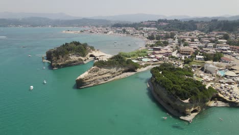 Scenic-Sidari-coastline,-Emerald-water-with-rock-formations,-Corfu-Island,-Aerial-Orbiting