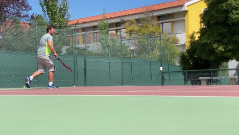 male-professional-tennis-player-hits-the-ball-with-a-racket,-practice-game-on-the-tennis-court,-hits-off-the-opponent's-serve-during-tennis-match,-4k-slow-motion