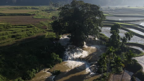 Aerial-View-Of-Waikelo-Sawah-Waterfall-And-Rice-Paddy-Field-In-Tema-Tana,-Wewema-Timur,-Southwest-Sumba-Regency,-East-Nusa-Tenggara,-Indonesia