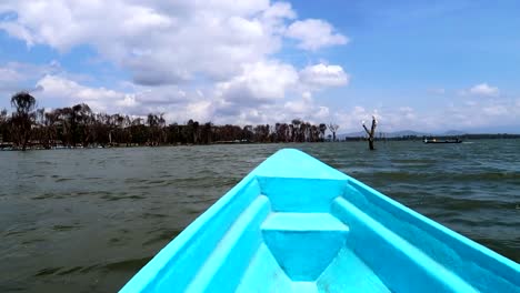 Panoramic-view-from-a-small-blue-boat-floating-on-Lake-Naivasha,-Kenya