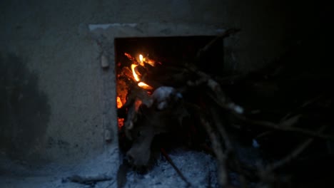 Close-up-gimbal-shot-of-burning-woods-at-traditional-Indian-stove