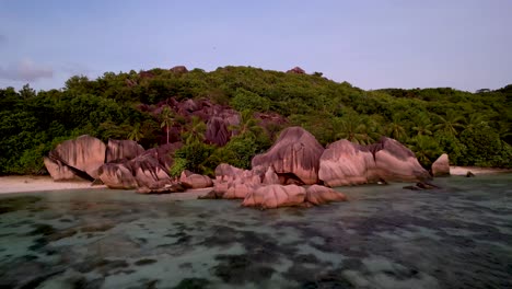 Sunset-on-La-Digue-island-Seychelles-aerial-view-of-Anse-Source-D'argent-beach-with-boulders-and-palm-trees