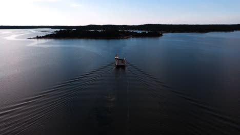 Aerial-view-foillowing-a-car-ferry-in-the-archipelago-of-Aland-islands,-Finland