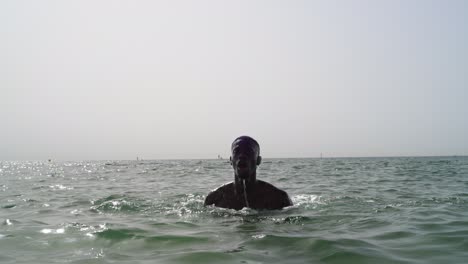 Black-athlete-football-player-doing-aqua-training-at-the-beach-in-the-ocean
