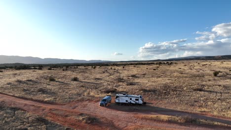 Pullback-Over-Sweeping-Sedona-Desert-Landscape-With-Praked-Motorhome-During-Summer-In-Arizona
