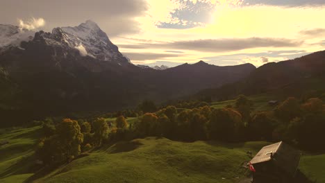 aerial-drone-footage-pushing-in-over-alpine-meadows-towards-Eiger-North-Face,-Grindelwald-autumn