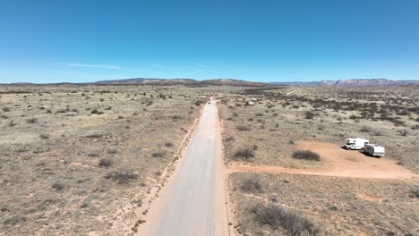 Flying-Over-Asphalt-Road-Through-Arid-Desert-Landscape-In-Sedona,-Arizona,-USA