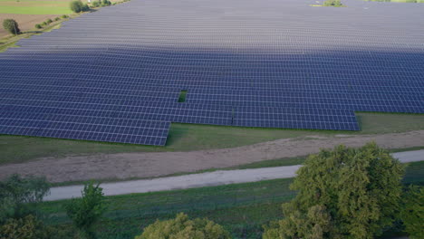 Aerial-View-Of-Rows-Of-Solar-PV-Farm-With-Descending-Shot,-Tilt-up