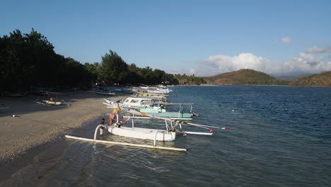Row-Of-Boats-Moored-At-The-Beach-In-Lombok-Island-During-Summer-In-Indonesia