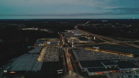 Aerial-night-hyperlapse,-busy-rush-hour-traffic-on-shopping-street-in-Vaasa,-Finland