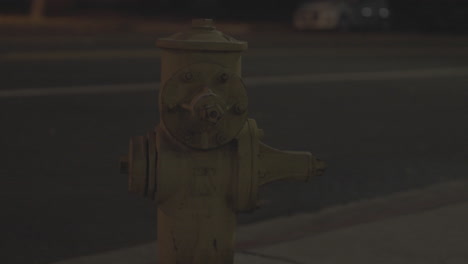 Yellow-Fire-hydrant-and-street-with-traffic-during-a-night-in-NOHO-Walk