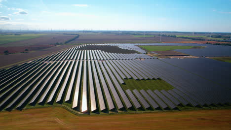 -Massive-Solar-Power-Plant-on-Sunny-Day-in-Poland---Aerial-Panning