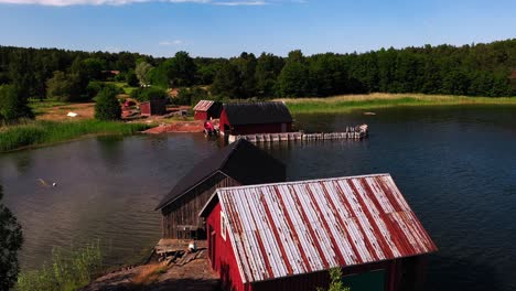 Aerial-view-over-Boatsheds-on-the-coast-of-Aland,-sunny-summer-day-in-Finland