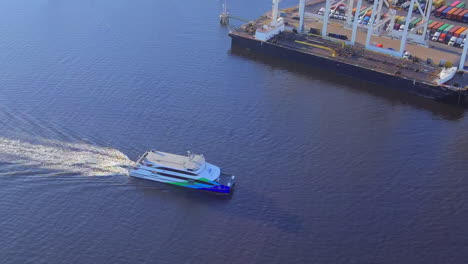 Aerial-view-rotating-above-San-Francisco-Alameda-ferry-leaving-Oakland-shipping-port-estuary