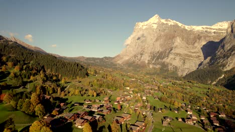 aerial-drone-footage-dolly-left-to-right-over-colorful-Grindelwald-village-in-front-of-Wetterhorn-in-Swiss-Alps