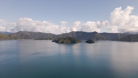 Wide-angle-aerial-approach-of-Allports-Island-in-the-bay-of-Picton-on-a-sunny-morning