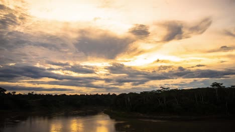 Dramatic-Day-to-Night-Timelapse-from-sunset-over-tambopata-river-to-the-moon-setting-in-night-sky-with-changing-colors-elements-over-the-forest-sky,-Peru