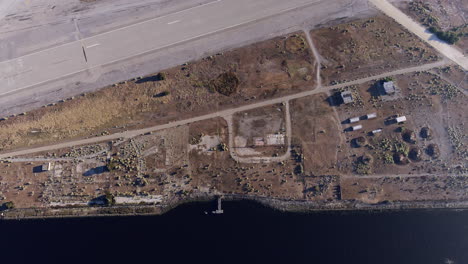 Aerial-view-looking-down-flying-over-decommissioned-Alameda-naval-base-runways,-San-Francisco