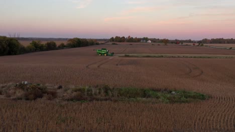 Combine-harvester-in-field-during-harvest-season-at-sunset