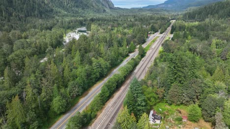 High-up-aerial-view-of-train-tracks-running-through-the-Cascade-Mountains-in-Washington-State