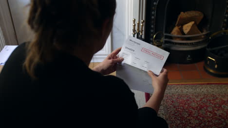 An-unrecognizable-female-opening-a-debt-letter