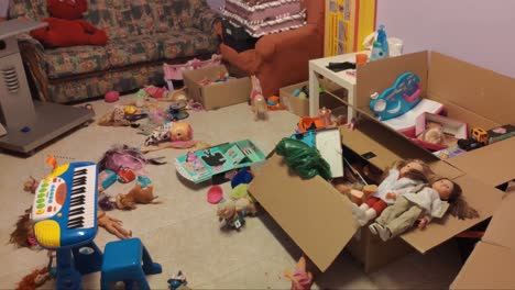 room-for-children's-games-with-many-toys-thrown-on-the-floor-creating-clutter-boxes-with-dolls,-sofa-and-piano-toy,-shooting-traveling-backwards,-Orders,-Galicia,-Spain
