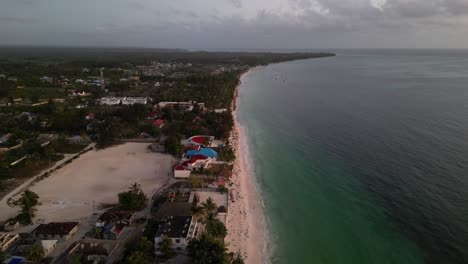 Uroa-beach-shore-homes-in-Zanzibar-Island-Tanzania-Africa-at-sundown,-Aerial-flyover-shot