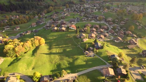 aerial-drone-footage-pushing-in-Grindelwald,-Autumn-sunset-colors