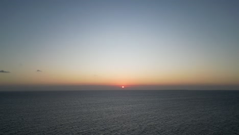 Sunset-in-the-Indian-Ocean-at-Kusini-beach-East-Zanzibar-Island,-Tanzania-Africa,-Aerial-high-shot
