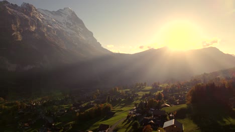 Luftaufnahmen-Von-Drohnen-Von-Links-Nach-Rechts-über-Dem-Dorf-Grindelwald-Mit-Atemberaubendem-Blick-Auf-Die-Eiger-Nordwand-Bei-Sonnenuntergang