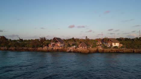 Kusini-beach-seaside-resort-in-East-Zanzibar-Island-Tanzania-Africa,-Aerial-pan-left-shot