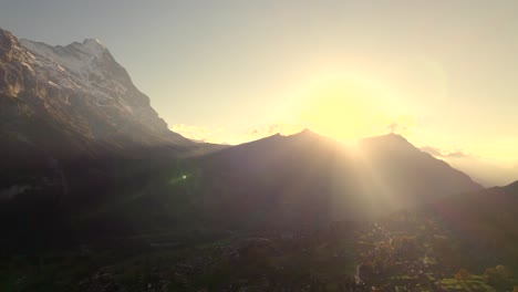 aerial-drone-footage-pushing-in-over-Grindelwald-with-sunset-view-of-Eiger-North-Face