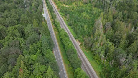 Overhead-aerial-view-of-a-highway-running-parallel-to-a-railroad-in-Baring,-Washington
