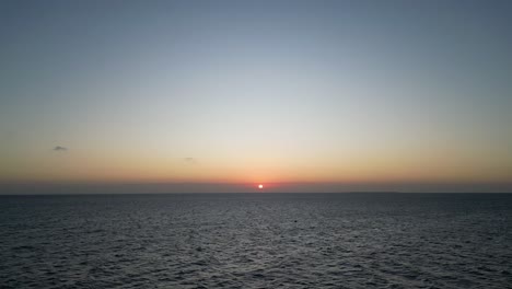 Indian-Ocean-Sunset-at-Kusini-beach-East-Zanzibar-Island,-Tanzania-Africa,-Aerial-rising-pedestal-shot