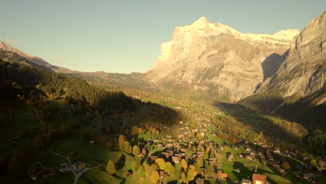 aerial-drone-footage-pushing-in-over-Grindelwald-village-with-sunset-views-of-Mount-Wetterhorn