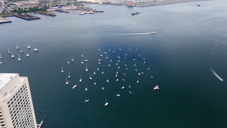 Aerial-Over-Downtown-Boston-In-Massachusetts-With-View-Of-Boats-Moored-In-Boston-Harbor