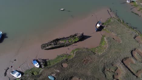 Aerial-View-Of-A-Shipwreck-Dock-Near-Salt-Marshes-In-Tollesbury-Marina,-Essex,-UK