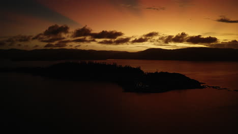 Isla-De-Ensueño-En-Australia-Al-Atardecer-Con-Un-Cielo-Naranja-Brillante-Y-Nubes