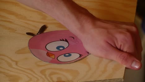 A-character-from-Angry-Birds-is-sawn-out-of-a-wooden-plate