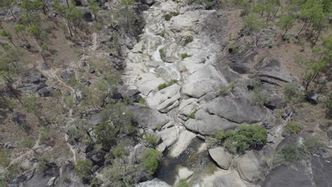 Water-Cascades-At-Emerald-Creek-Falls-In-Mareeba,-Australia---aerial-drone-shot