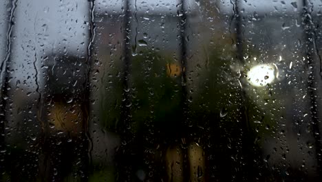 Close-Up-View-At-Window-Covered-In-Rain-Droplets-Behind-Safety-Bar