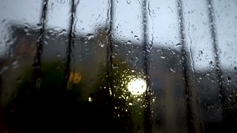 Close-Up-View-At-Rain-Water-Running-Down-Window-With-Safety-Rail