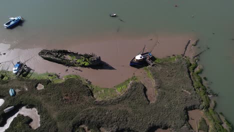 Old,-Abandoned-Shipwreck-on-Coast-of-the-Blackwater-River-Marsh-Swamps,-Essex,-UK---Aerial-Top-Down-View