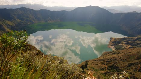 Quilotoa-lake-in-Ecuador,-clouds-reflecting-in-water