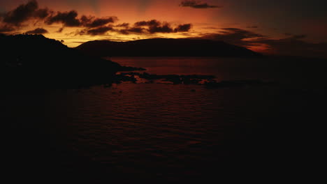 Bright-orange-sunset-sky-over-tropical-islands-and-ocean-in-Australia