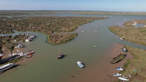 Aerial-Panoramic-View-Of-Boats-Mooring-In-Tollesbury-Marina-With-Salt-Marshes-In-Essex,-United-Kingdom