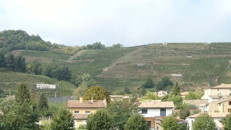 View-across-hills-showing-vineyards-and-onto-Chateaubourg,-France