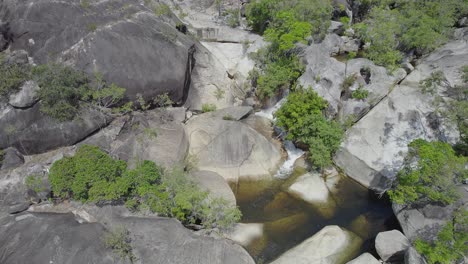 Emerald-Creek-Falls-With-Granite-Boulders-In-Mareeba,-Australia---aerial-drone-shot