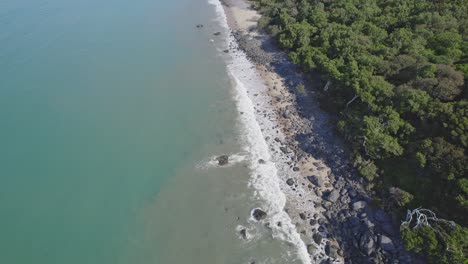 Ocean-Waves-Splashing-On-Rocky-Shore-At-Borderline-Beach-In-Wangetti,-QLD,-Australia---aerial-drone-shot
